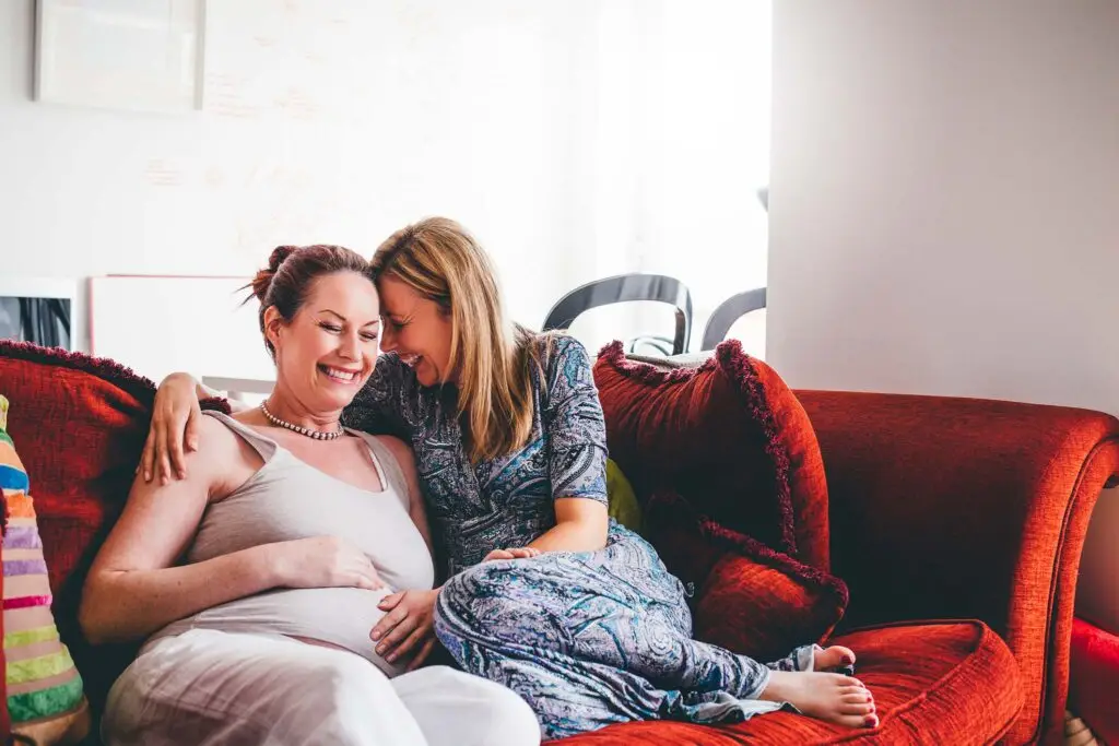 Same sex pregnant couple smiling