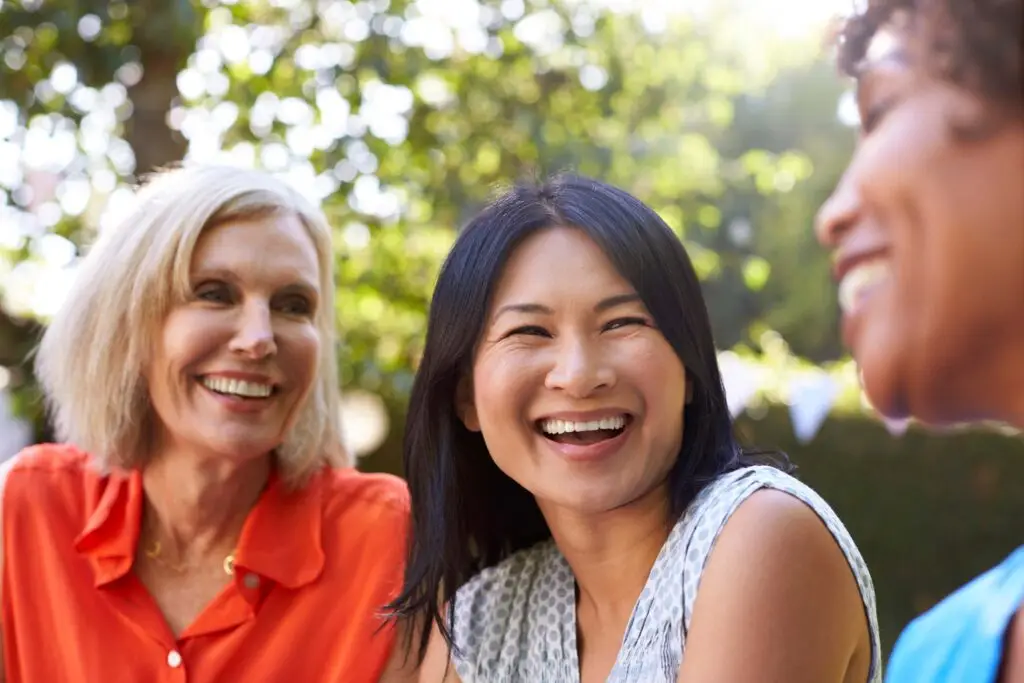 Mature Female and friends socialising in the backyard together