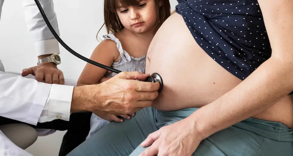 Pregnant woman having fetal monitoring by doctor