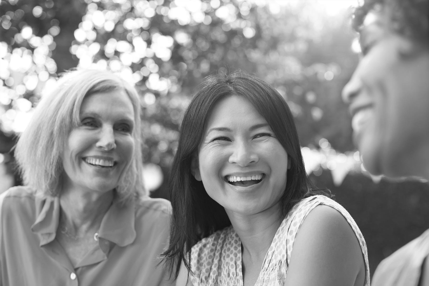 Mature Female and friends socialising in the backyard together