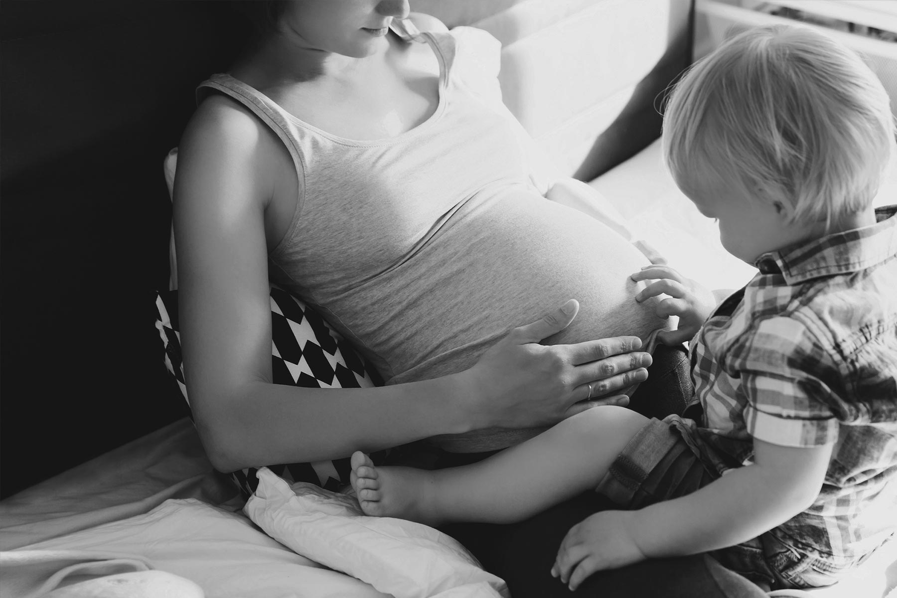 Pregnant mother and son at home